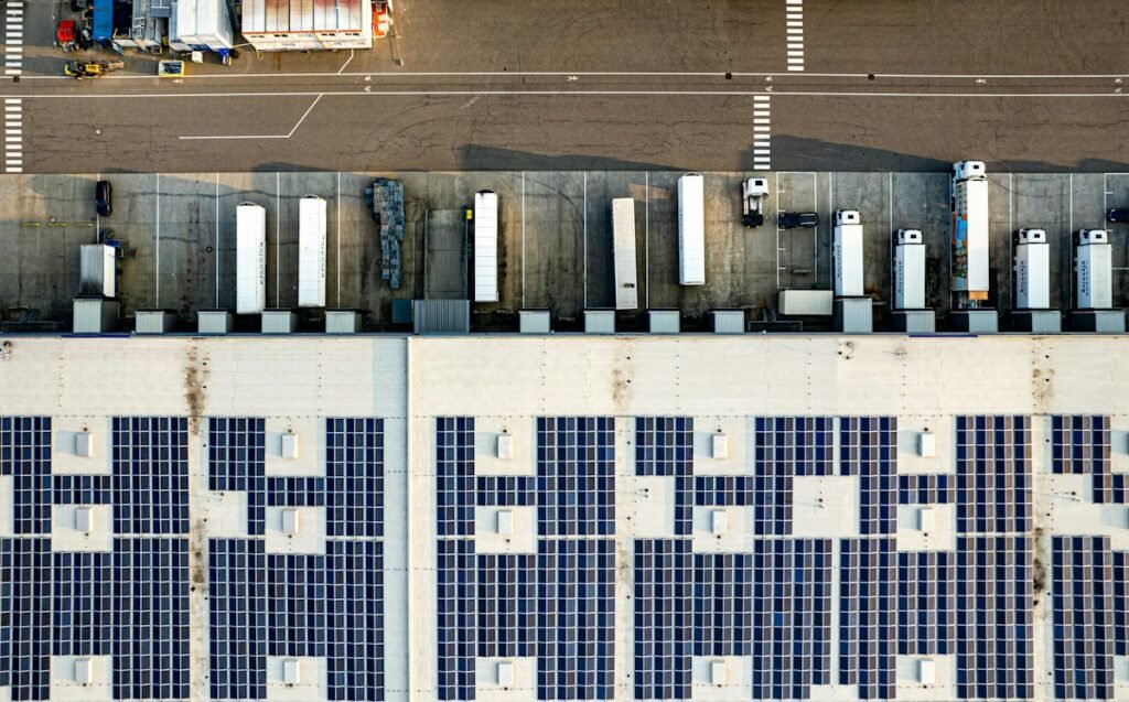 Solar panel arrays covering a large building rooftop