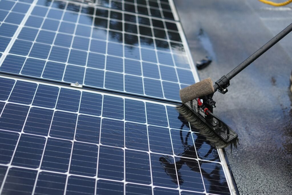 A worker cleaning solar panels with suitable equipment